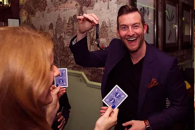 Wedding guests laughing at pickpocket magic